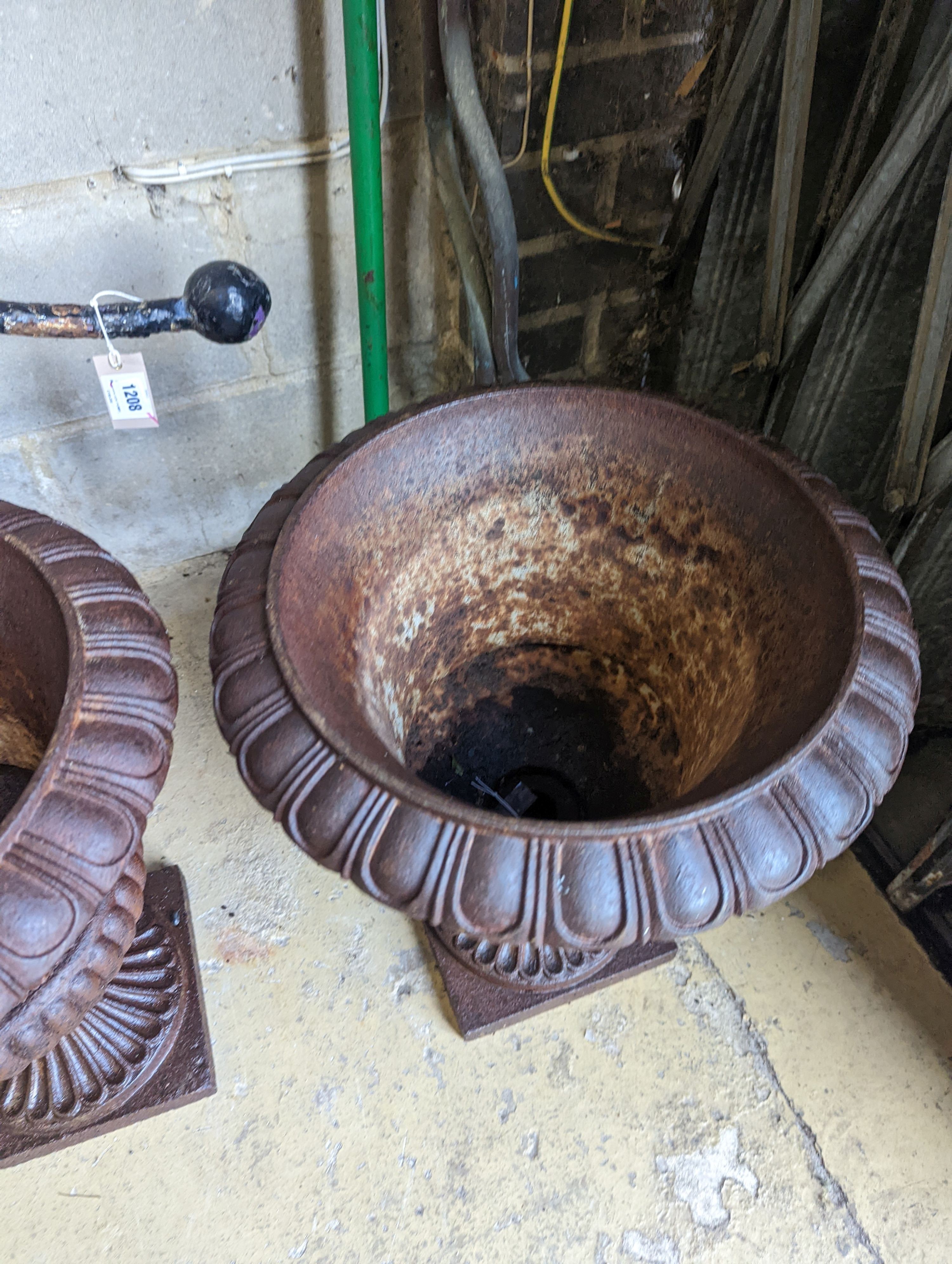 A pair of Victorian circular cast iron campana garden urns, diameter 38cm, height 46cm